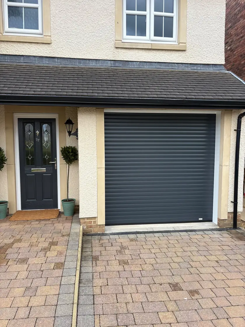 New anthracite grey insulated roller garage door fitted to the same home
